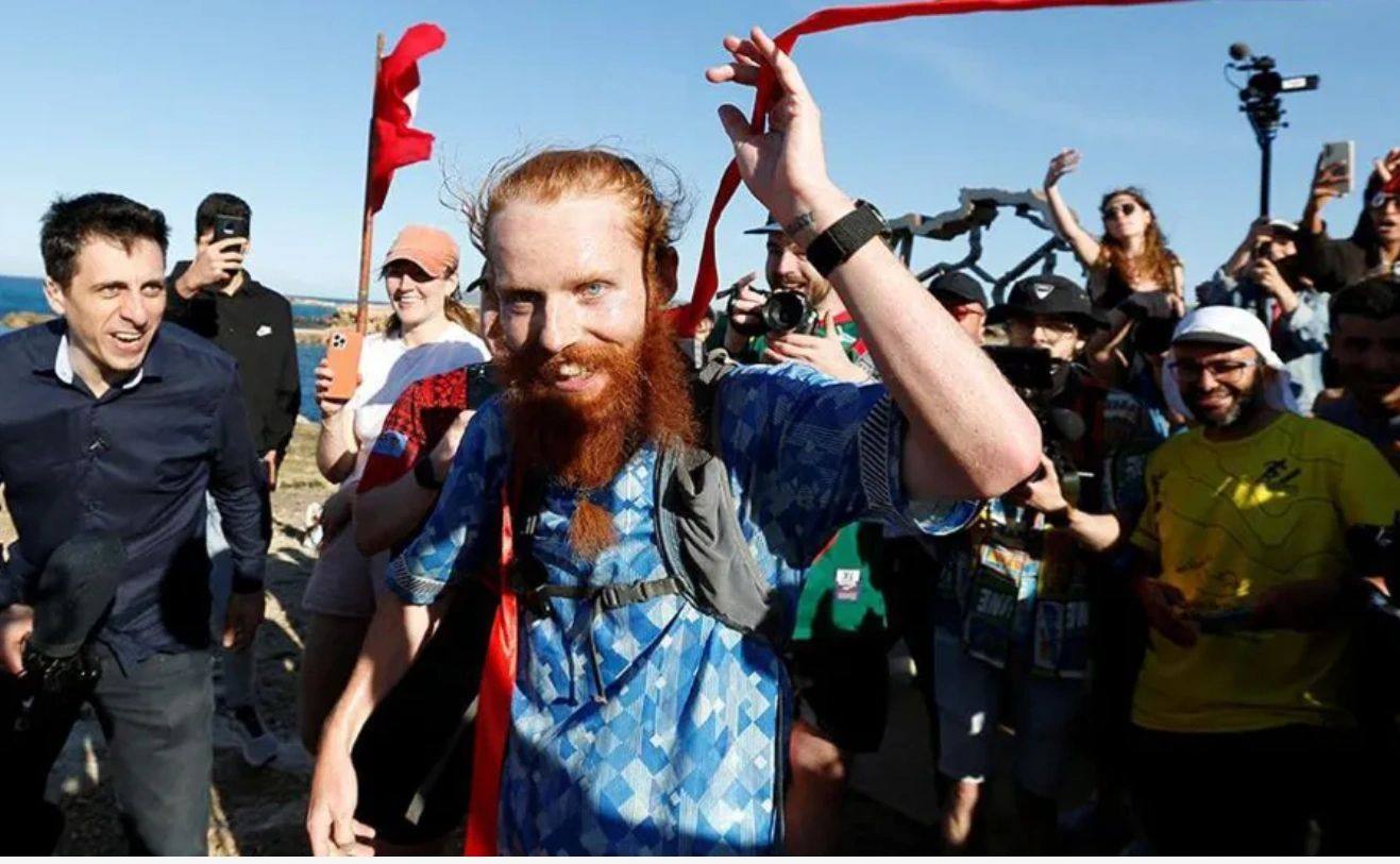 Cook finishes his epic adventure. Contment comes from focusing on the experience not the outcome. Photo: Reuters 